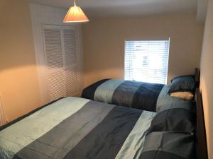 a bedroom with two beds next to a window at Rj s house in Merthyr Tydfil