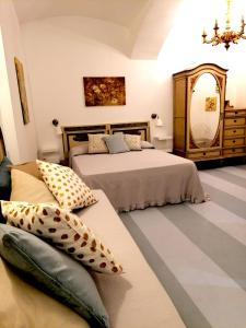 a bedroom with two beds and a mirror at La casa di Chloé in Turin