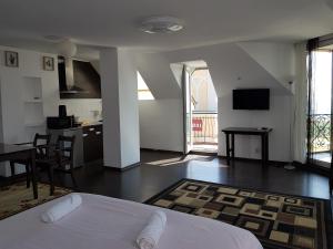 a bedroom with a bed and a kitchen with a table at Sunny Island Obzor in Obzor