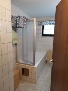 a bathroom with a shower and a bath tub at Ferienwohnung Eppacher in Trins