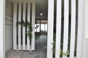 an open door to a hallway with plants at Apartamentos Acuario in Denia