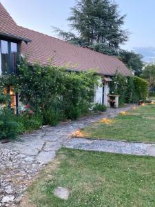 a house with a pathway leading to a yard at Villa Nymphea in Saint-Pierre-dʼAutils +1 photo