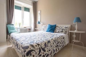 a bedroom with a bed with blue pillows and a window at Blunotte Potenza in Potenza