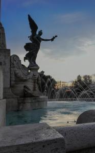 a statue of a woman with an umbrella on a fountain at Antica Terrazza Frascati in Frascati