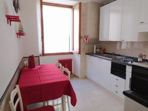 a kitchen with a table with a red table cloth on it at Agretta Sea View Apartment in Vernazza