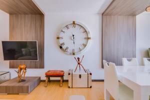 a dining room with a large clock on the wall at Gold Suites - Luxurious apartment - Sea view in Vilamoura