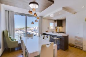 a kitchen and dining room with a large white table and chairs at Gold Suites - Luxurious apartment - Sea view in Vilamoura