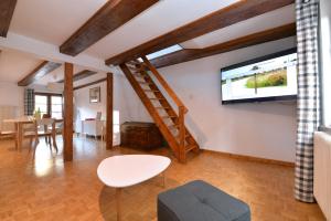 a living room with a flat screen tv on the wall at Appartement La Grande Terrasse du Centre in Colmar