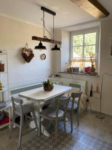 a kitchen with a white table and chairs at An der Walnuss in Feilsdorf +20 photos