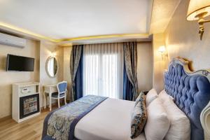 a hotel room with a bed and a television at Ayasultan Hotel in Istanbul
