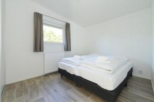 Postel nebo postele na pokoji v ubytování Hart van Zeeland