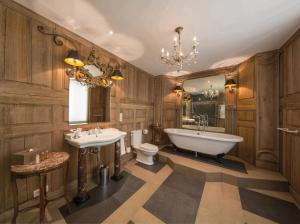 
a bathroom with a large tub and a large mirror at Louise sur Cour in Brussels
