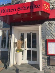 a entrance to a kitchen restaurant with a sign over a door at Landgasthof Hüttenschenke in Kirchen