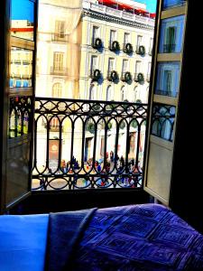 a window that has a bunch of windows in it at Hostal Riesco in Madrid