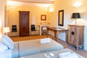 a bedroom with a bed and a desk and a desk at Mas De Rosemarie in Joucas