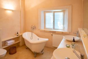 a bathroom with a tub and a toilet and a sink at Mas De Rosemarie in Joucas +68 photos