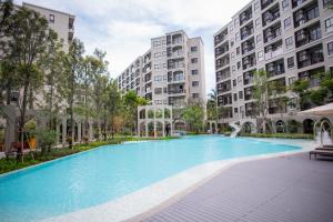 a swimming pool in the middle of some apartment buildings at Lacasita484 In Huahin in Hua Hin