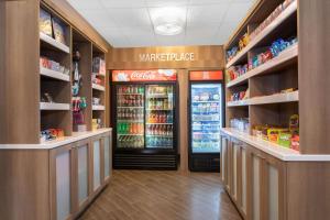 a grocery store aisle with a refrigerator in a store at Days Inn by Wyndham Orlando Conv. Center/International Dr in Orlando
