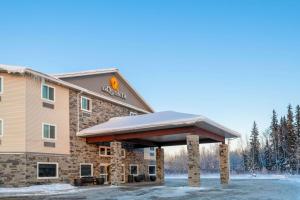 a resort building with a snow covered roof at La Quinta by Wyndham Fairbanks Airport in Fairbanks