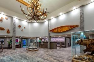 a lobby with a bear exhibit and a chandelier at La Quinta by Wyndham Fairbanks Airport in Fairbanks