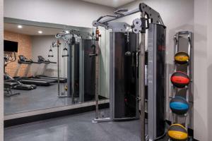 a gym with a row of machines and a mirror at La Quinta by Wyndham Fairbanks Airport in Fairbanks