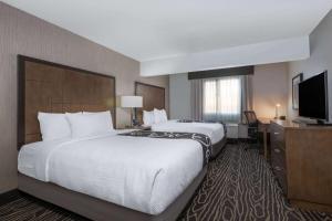 a hotel room with a large bed and a flat screen tv at La Quinta by Wyndham Fairbanks Airport in Fairbanks