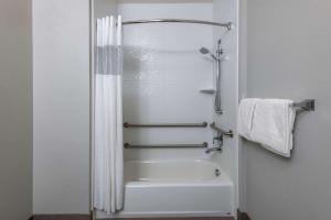 a bathroom with a shower and a white tub at La Quinta by Wyndham Fairbanks Airport in Fairbanks