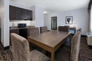 a dining room with a wooden table and chairs at La Quinta by Wyndham Fairbanks Airport in Fairbanks