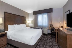 a hotel room with a bed and a television at La Quinta by Wyndham Fairbanks Airport in Fairbanks