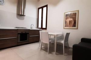 a kitchen with a table and chairs in a room at Your House in Olbia