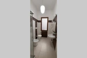 a bathroom with a toilet and a sink at Your House in Olbia