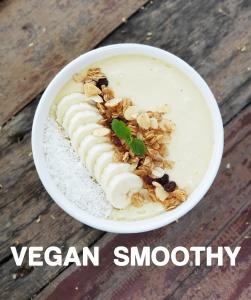 a bowl of vegan smoothie with nuts on top at PAN KLED VILLA eco hill resort in Chiang Rai