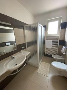 a bathroom with a sink and a toilet and a shower at Albergo Ristorante Val Vomano in Penna SantʼAndrea