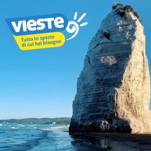 a rock on the beach with the title of the magazine at Residence San Luca Vieste in Vieste