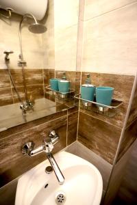 a bathroom with a sink and two bowls on a wall at Studio Ulpia in Plovdiv