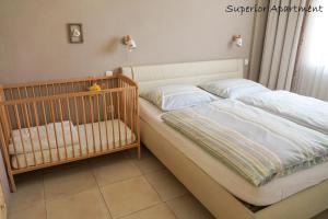 a crib with two pillows and a crib at Apartment Villa Carolina in Kranjska Gora