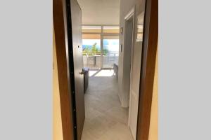 a door to a hallway with a view of the ocean at Sea view apartment in Loutraki
