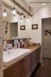 a bathroom with a large white sink and a mirror at Apartment Villa Carolina in Kranjska Gora