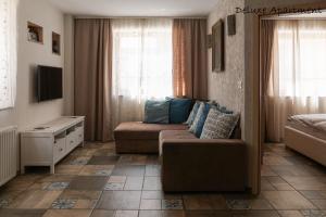 a living room with a couch and a tv at Apartment Villa Carolina in Kranjska Gora