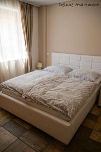 a large bed in a bedroom with a window at Apartment Villa Carolina in Kranjska Gora