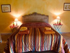 a bedroom with a bed with two lamps and towels on it at Tenuta Tenaglia in Serralunga di Crea