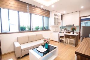 a living room with a couch and a kitchen at Canary Ha Noi Hotel in Hanoi +29 photos