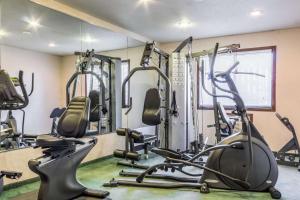 a gym with several treadmills and elliptical machines at Econo Lodge Sioux Falls North in Sioux Falls