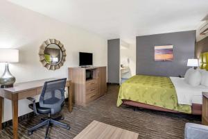 a hotel room with a bed and a desk and a computer at Quality Inn San Angelo in San Angelo