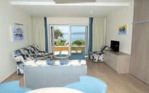 a living room with a couch and a view of the ocean at Apartments Villa Loznica in Brela