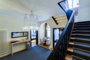 a living room with a staircase and a chandelier at Die Villa in Mannheim