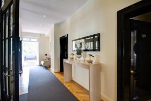 a room with a hallway with a counter with vases on it at Die Villa in Mannheim