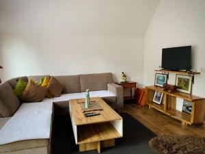 a living room with a couch and a coffee table at Art Resort in Peje