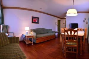 a living room with a couch and a table at Appartamenti Astoria La Villa in La Villa