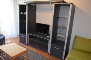 a large black entertainment center with a tv in it at Apartments Aneva in Baška